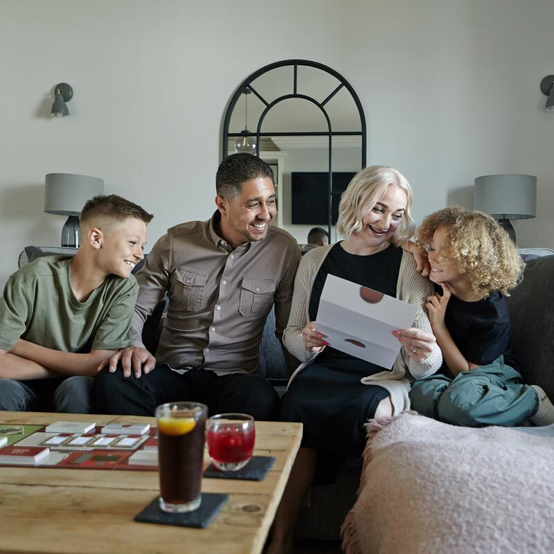 Lifestyle picture of a family playing the Official Taskmaster Board Game