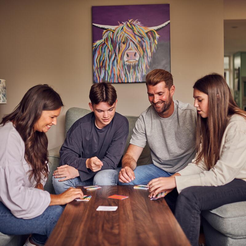 Family in their lounge playing bumfuzzle card game