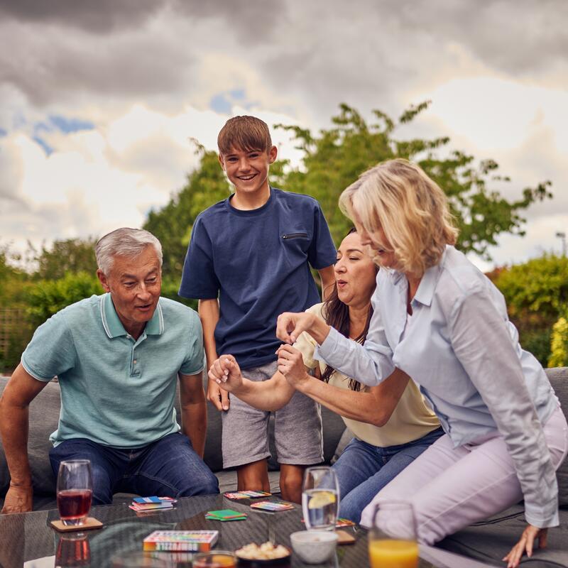 Family outside playing bumfuzzle card game