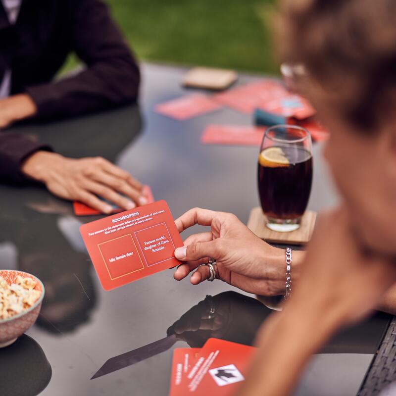House of games card game lifestyle image showing question card being read out